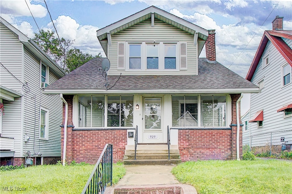 Bungalow-style house featuring a front lawn, brick siding, roof with shingles, and a chimney