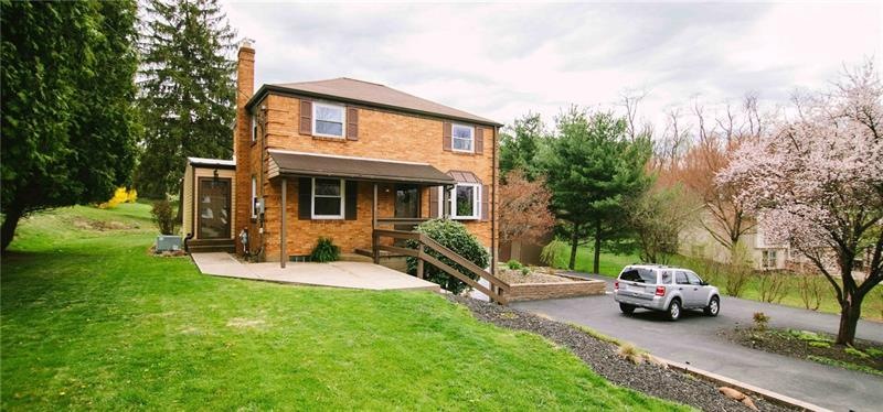 Brick 2 story with large front & backyard, spaciou