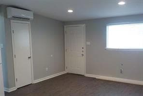 Entrance foyer featuring an AC wall unit and rece