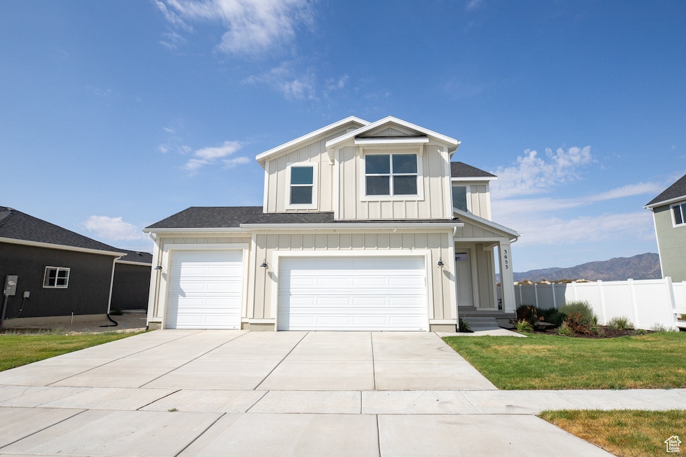 Exterior of Balsam floorplan with 3-car garage and fence adjoining a paved pathway.