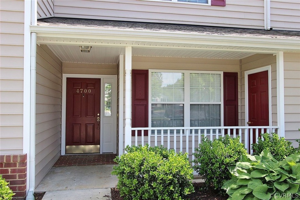 Welcoming covered porch with exterior storage cabi