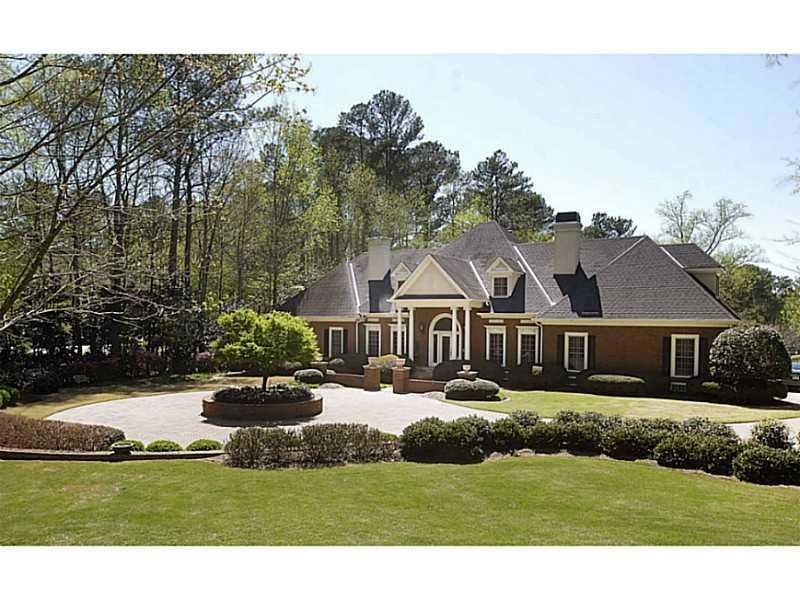 Exterior Front. Stately all brick home behind eleg