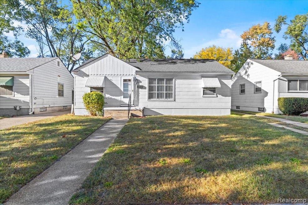 Bungalow-style house featuring a front lawn, board and batten siding, and roof with shingles