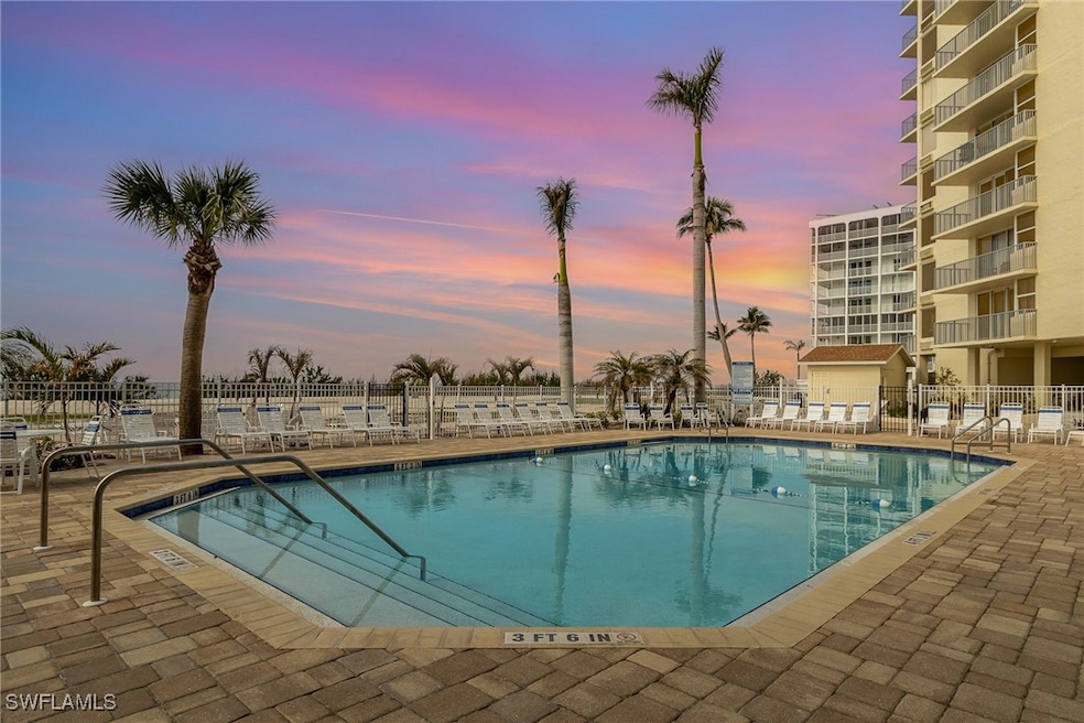 Pool at dusk featuring a patio