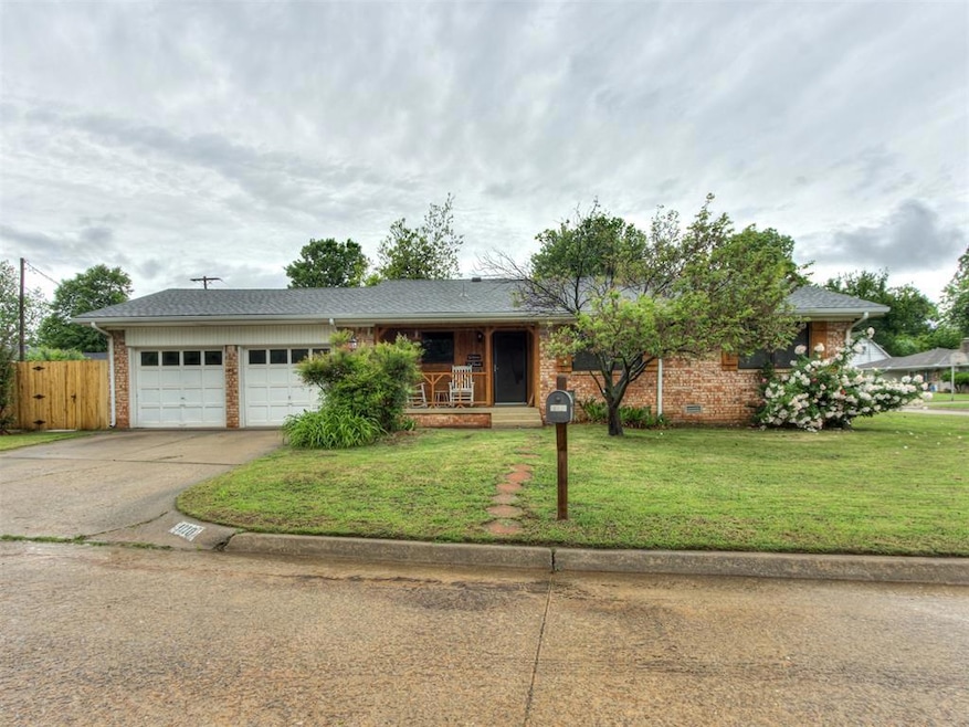 Single story home with covered porch, concrete dri