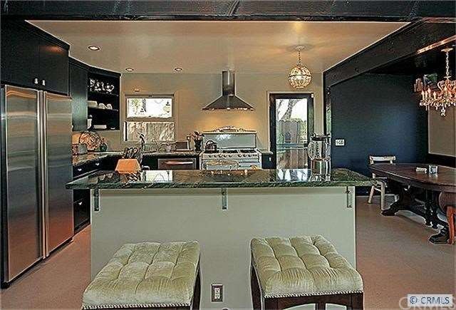 The large island with custom granite anchors this 