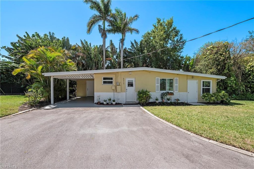 Single story home featuring a front lawn, an attac