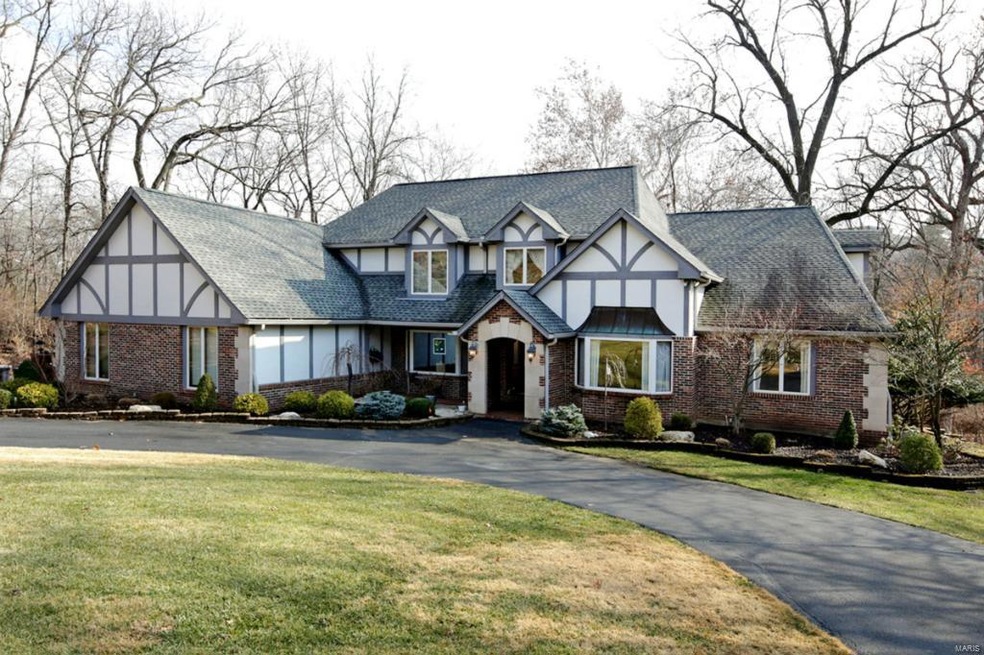 Stately Classic Tudor Design.  Circle Drive and perfectly manicured grounds