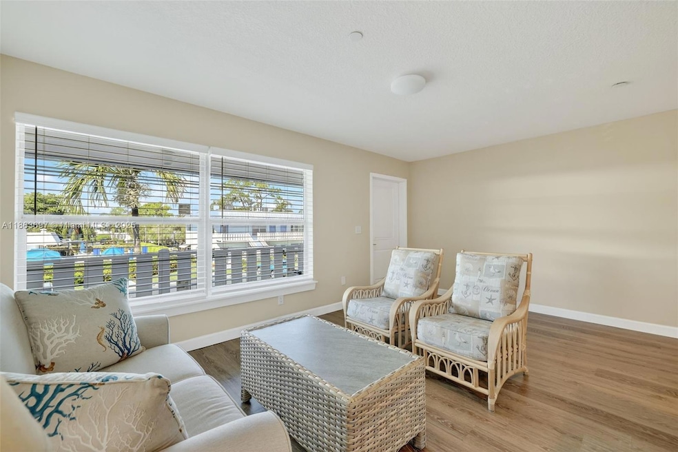 Immerse yourself in the comfort of your living space, where the stunning backdrop of the pool area enhances your relaxation and enjoyment.