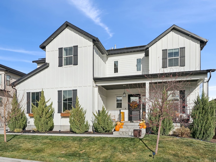Modern inspired farmhouse featuring board and batten siding, a porch, and a front lawn