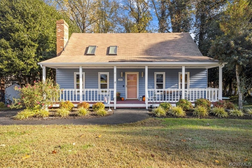 View of front of home with a front yard and covere