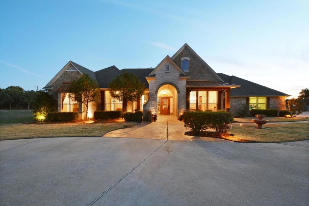 The main house welcomes you with a front circle drive, water feature and lush landscaping.