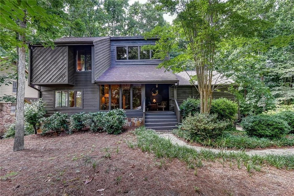 Nestled on a wooded, private lot, this soft-Califo