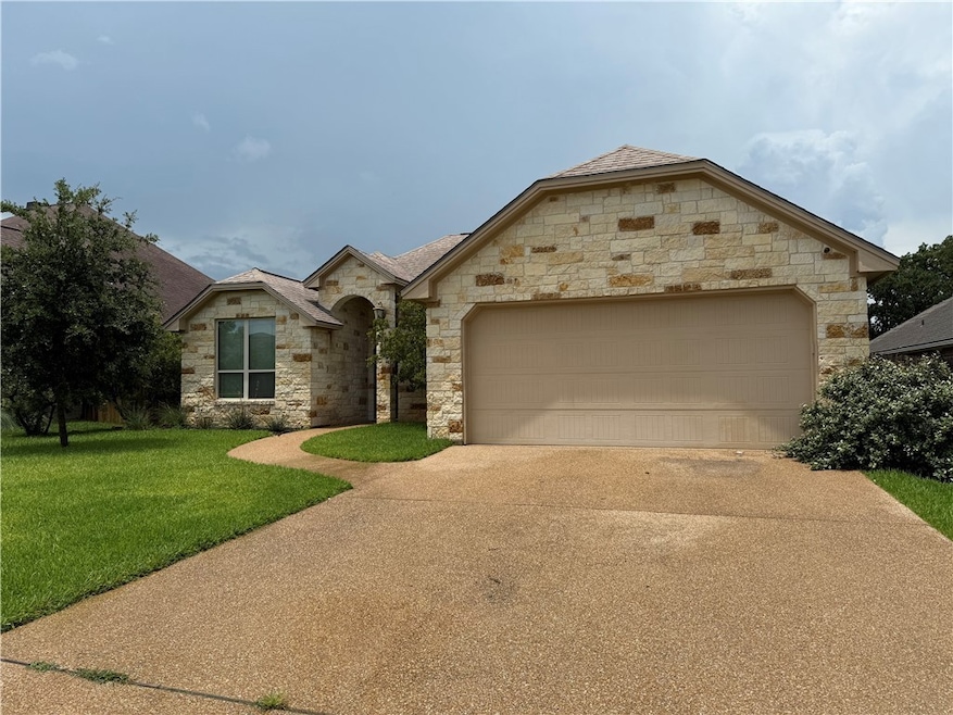 French country style house with stone siding, conc