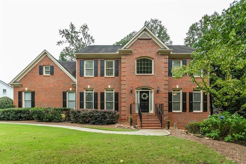 Pretty, brick home with side entry garage on large