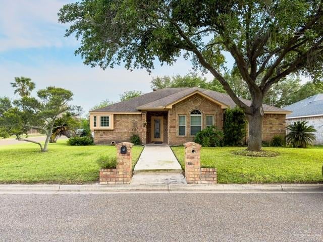 Ranch-style home featuring brick siding and a front yard