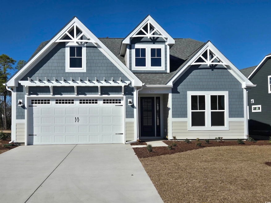 View of front of house with driveway and a shingle