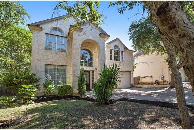 Beautiful white stone two story with tons of shade