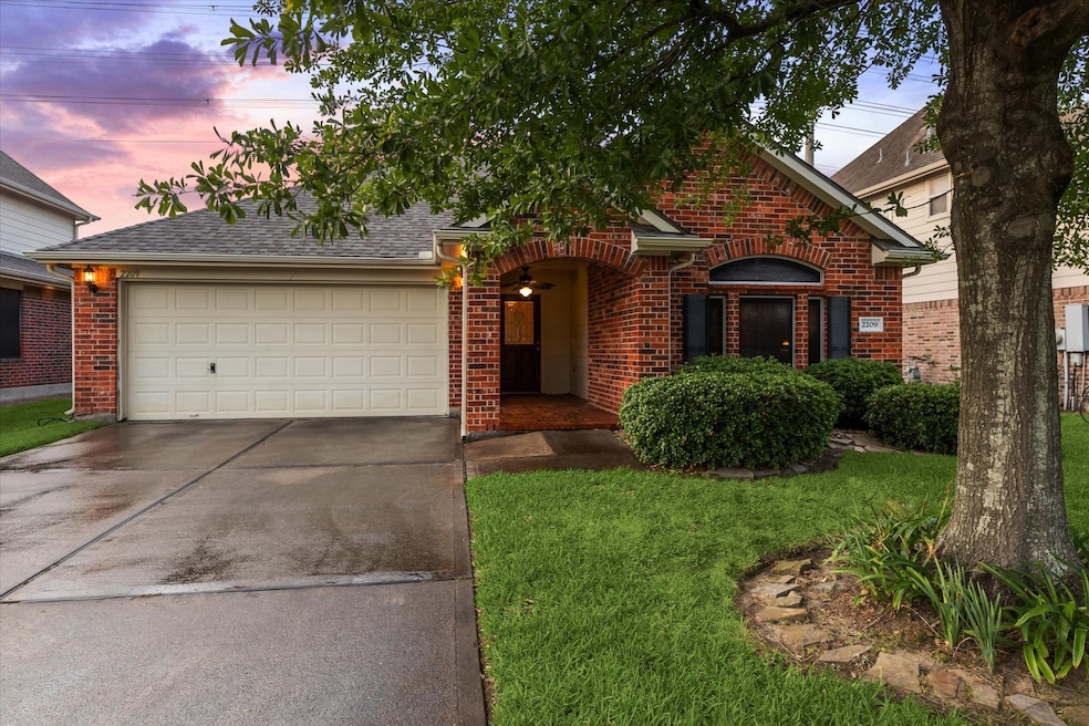 Charming brick home with a two-car garage and a we