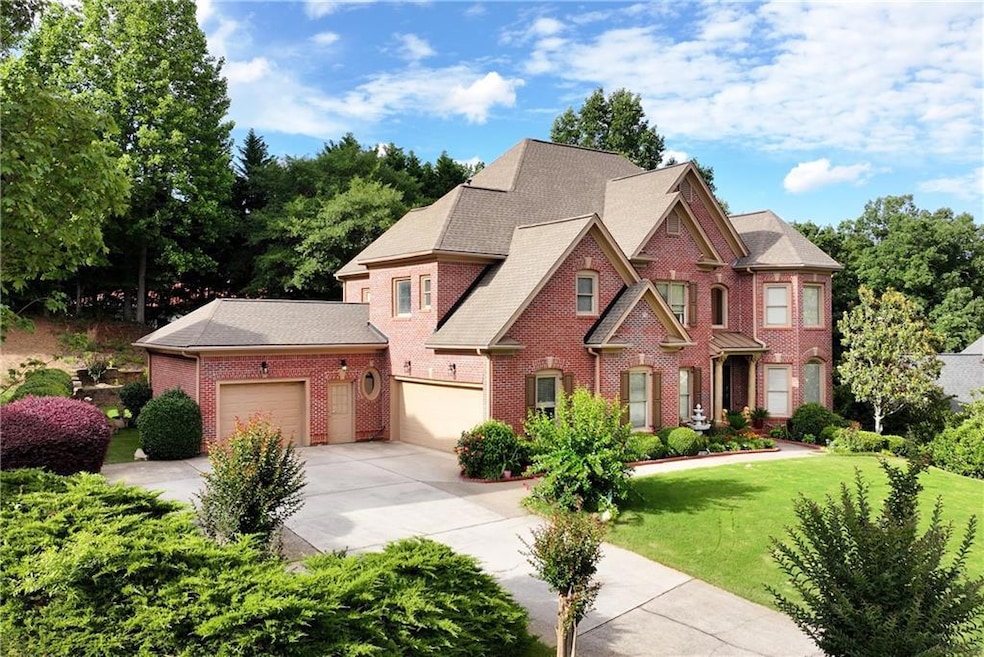 View of front of house with brick siding, driveway, a front yard, a garage, and a shingled roof
