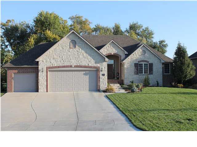 This custom home has plenty of curb appeal with a 