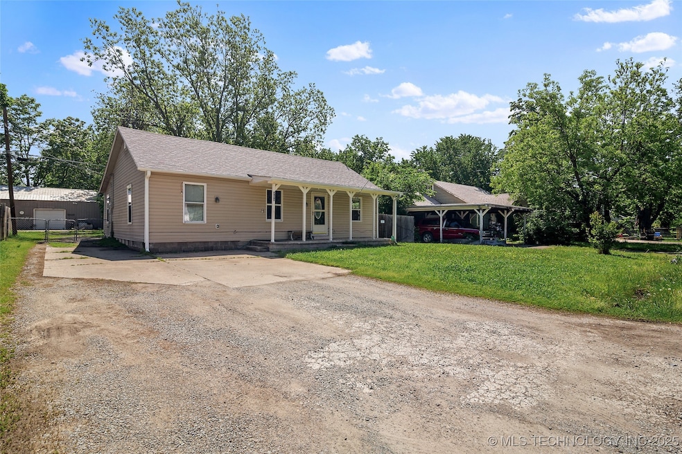 Ranch-style home with concrete driveway, a porch,