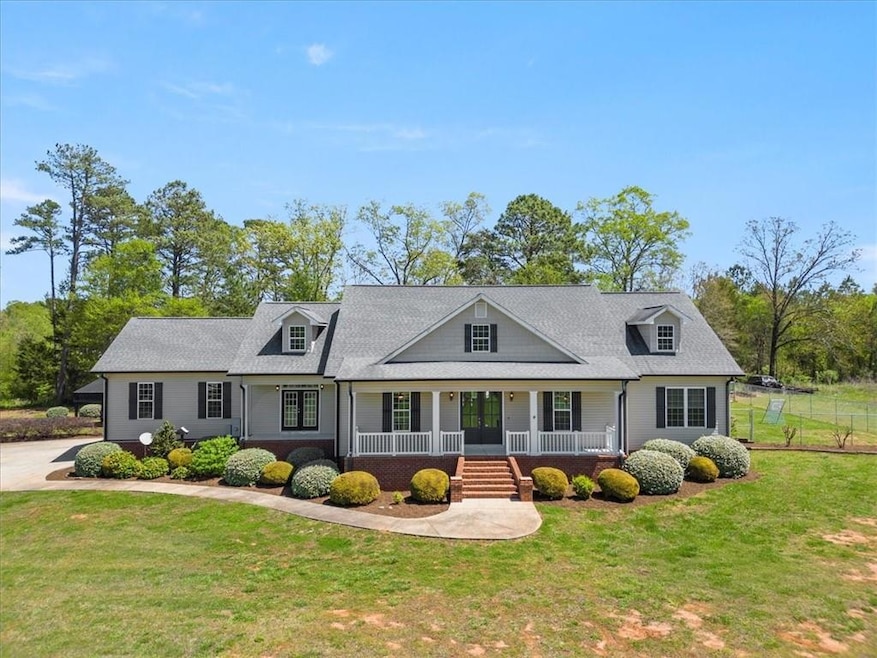 Cape cod house with covered porch and a front yard