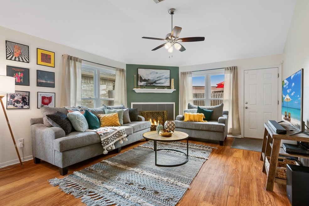 Cozy up in this beautiful living room with gas fireplace, tall ceilings, and updated flooring.