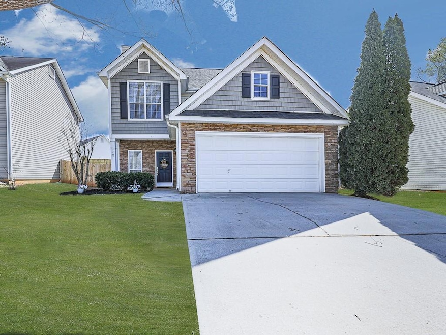 View of front of house with a front lawn and a gar