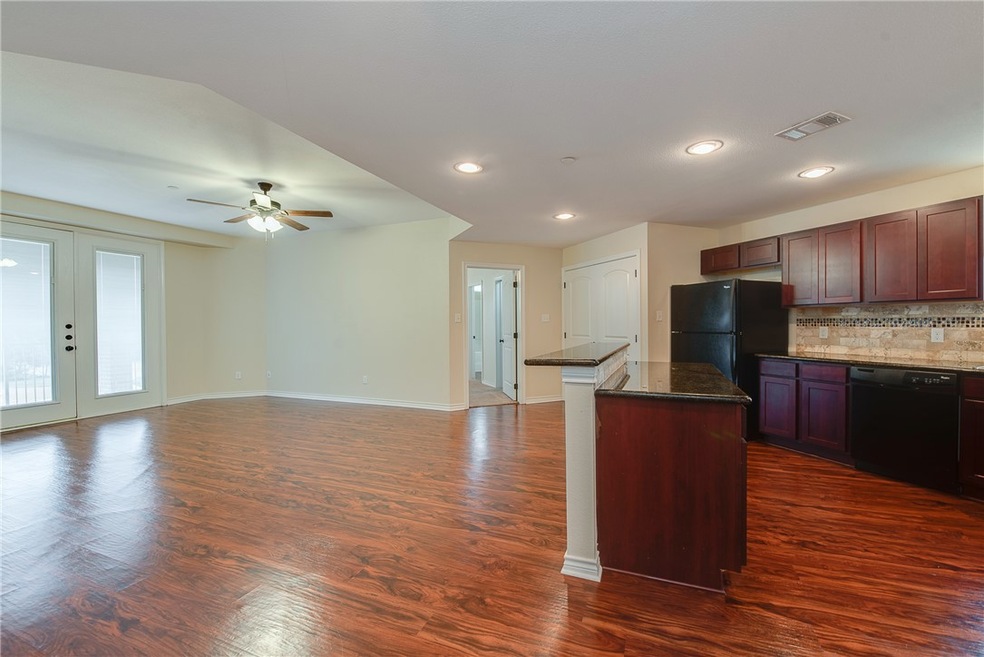 Kitchen featuring decorative backsplash, a center