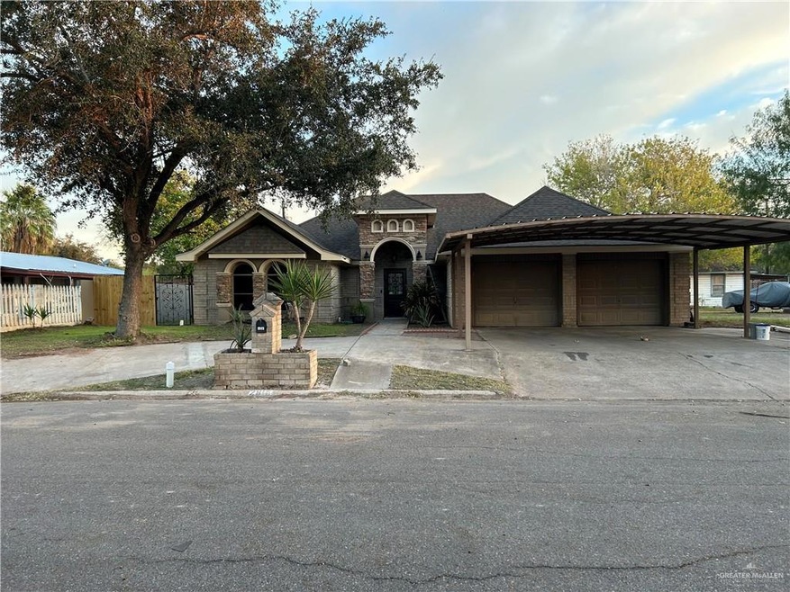 View of front of property featuring a carport and a garage