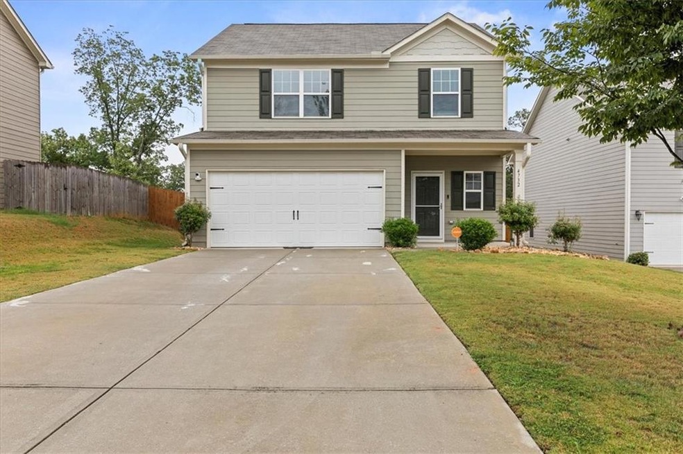 View of front of property with a garage and a fron