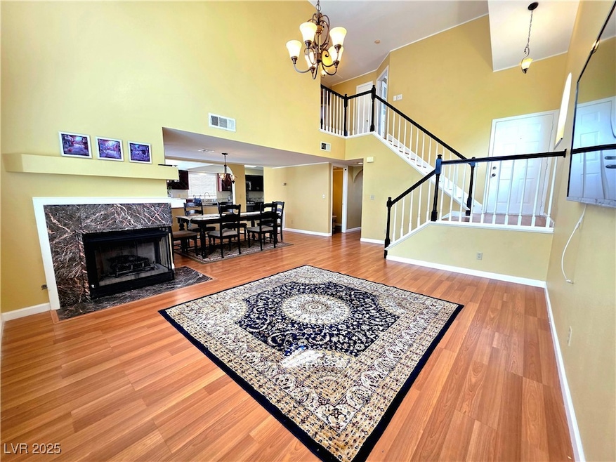 Living area with stairway, a chandelier, wood fini
