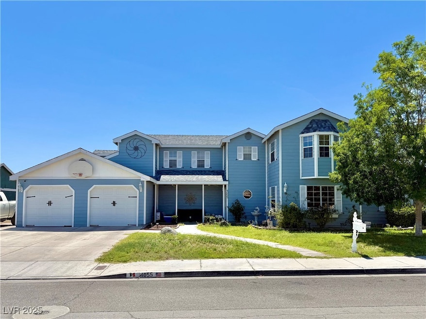 Traditional-style home with concrete driveway, a front yard, and a garage