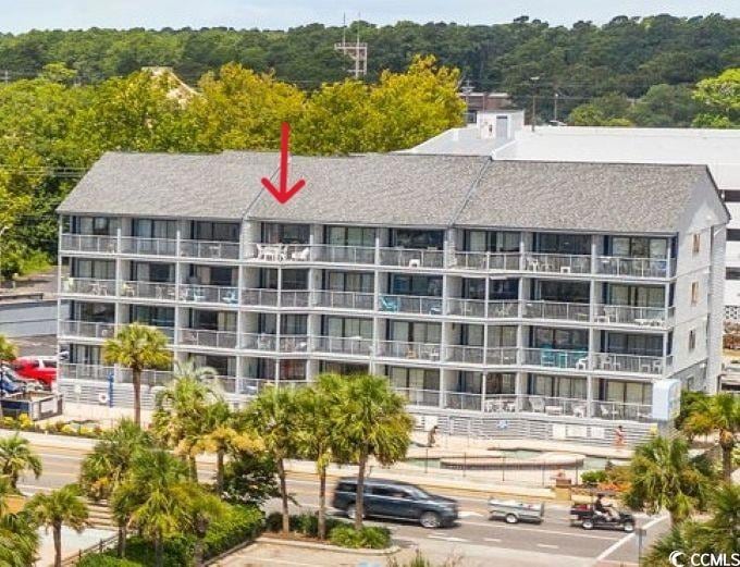 View of apartment building / complex with a wooded view