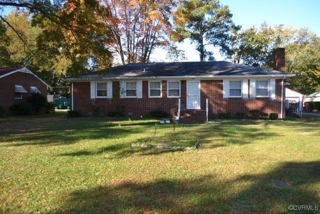 Ranch-style home featuring a front lawn