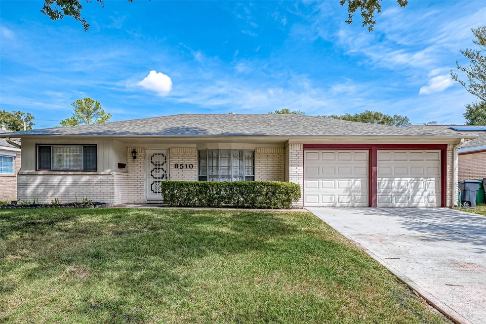 The home boasts a timeless mid-century exterior design with a gently sloping roofline and large windows, allowing for plenty of natural light.