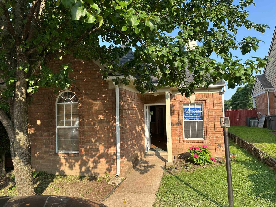 View of front of property with brick siding and cooling unit