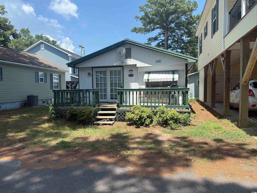 Back of house with a wooden deck