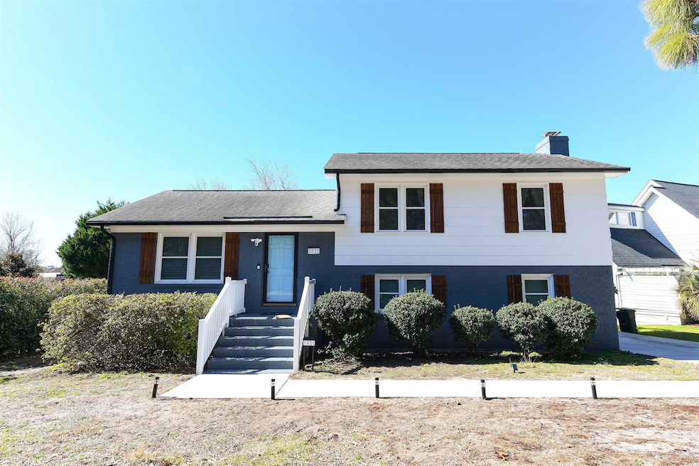 Split level home featuring a chimney