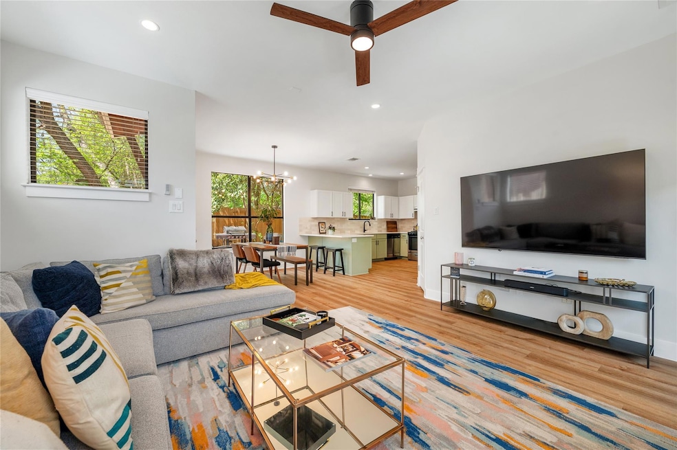 Living area with light wood-style flooring, ceili