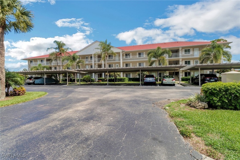 View of property featuring covered parking