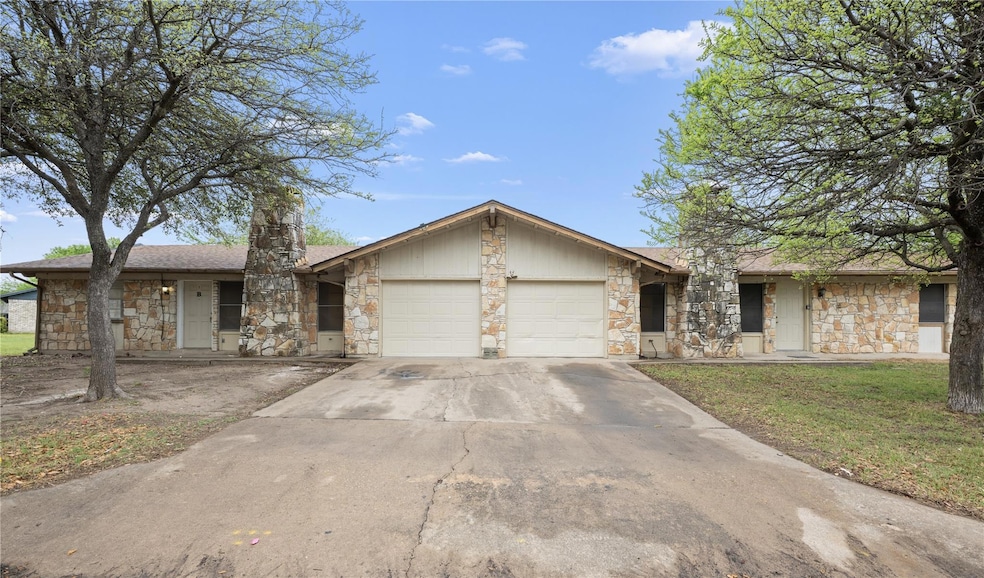 View of front of house with a front yard, stone s