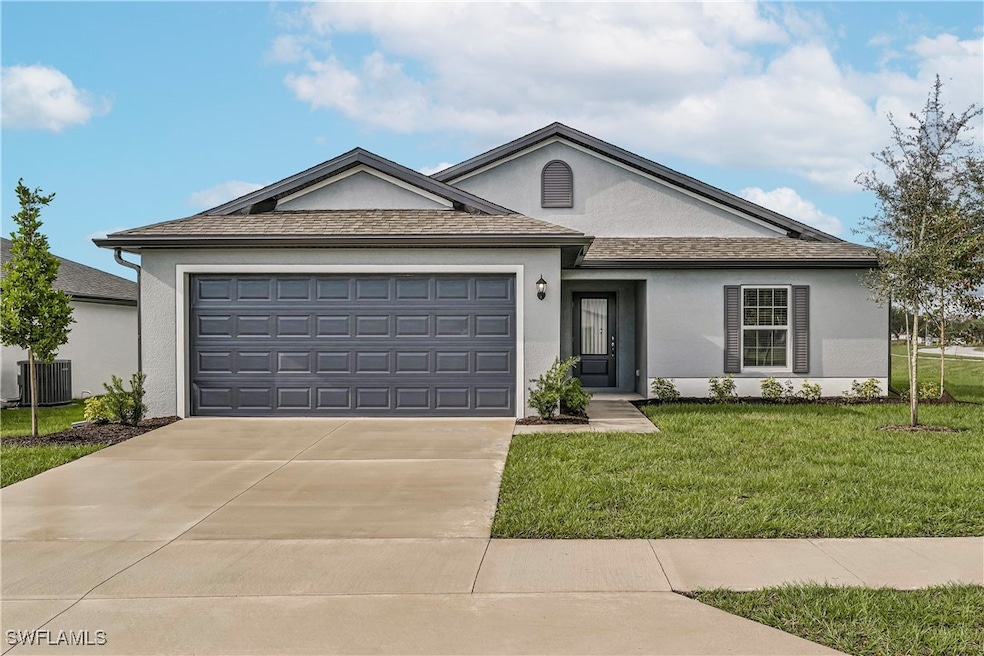 Ranch-style house featuring a garage, a front yard