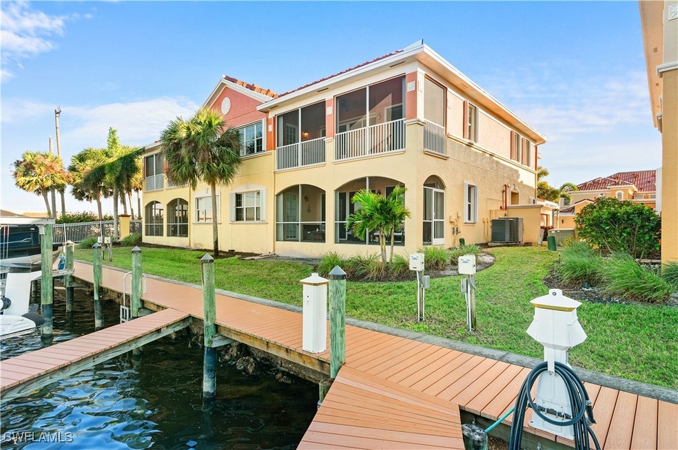 Dock area with a water view, a yard, and central a