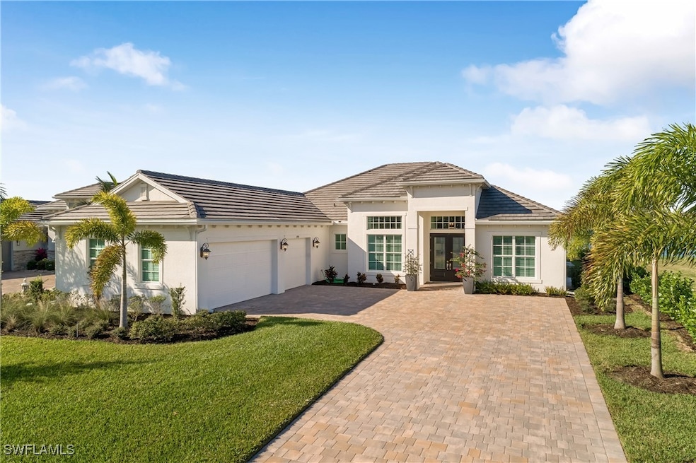 View of front of house with a front lawn, a garage