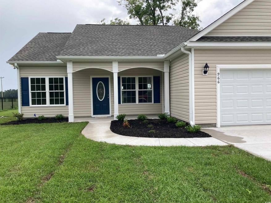 Single story home featuring a garage and a front lawn