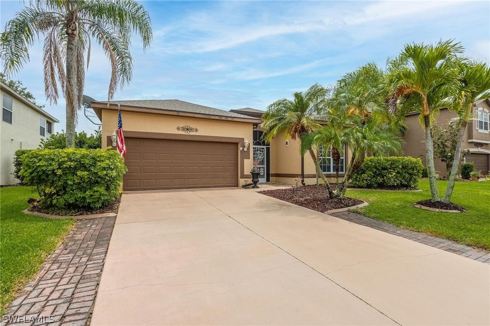 View of front of home featuring 2 car garage, matu