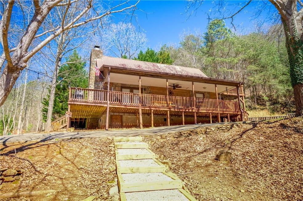 Rear view of house featuring a deck and ceiling fa