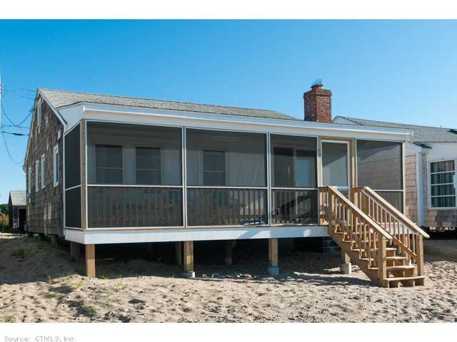 Exterior Back. Beach side with screened in porch.